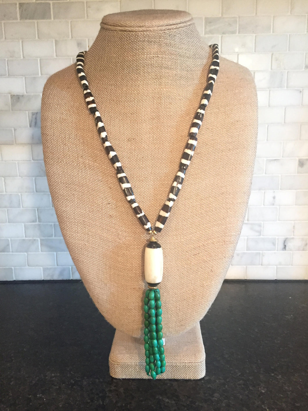 Brown and white bone necklace with beaded tassel